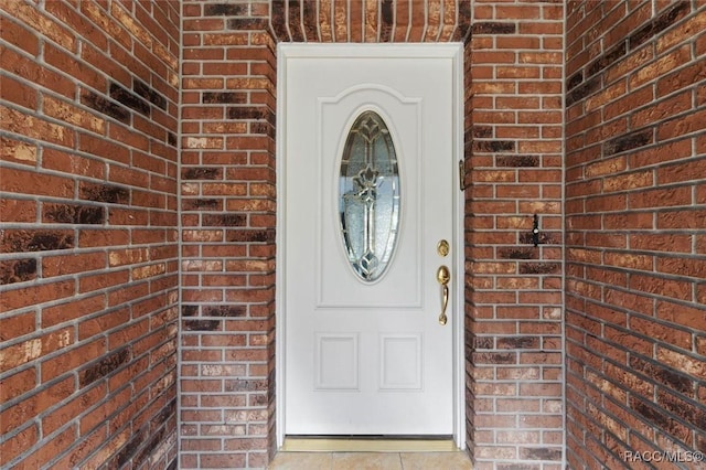 entrance to property with brick siding