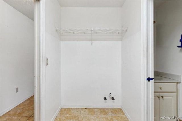 laundry room with baseboards