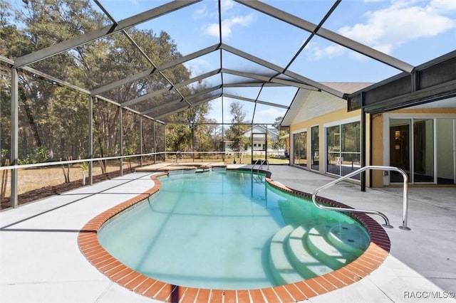 pool with glass enclosure and a patio area