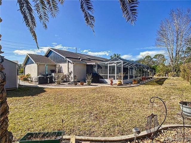 rear view of property with a lawn and glass enclosure