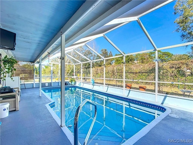 view of pool featuring a lanai and a patio area