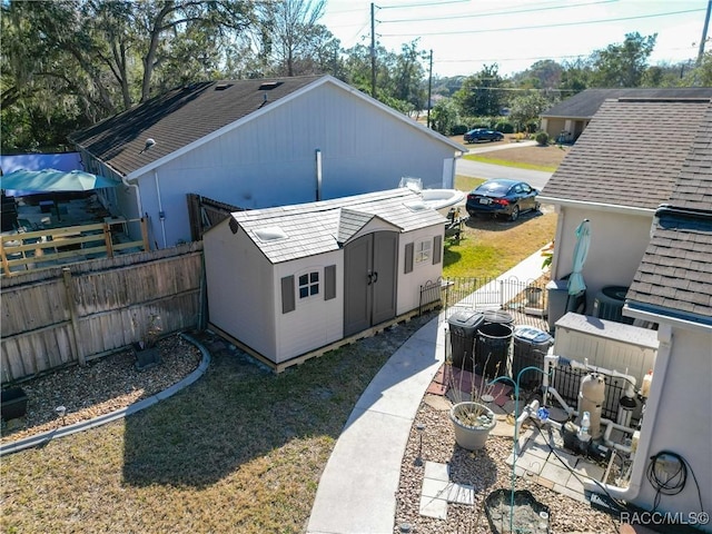 exterior space with a shed and a patio area