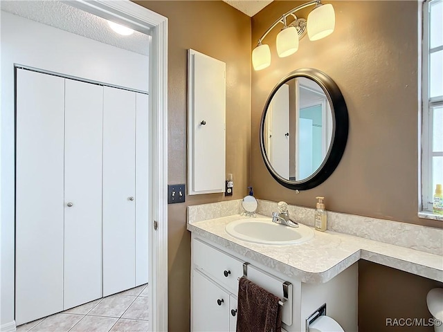 bathroom with vanity, tile patterned floors, and a textured ceiling