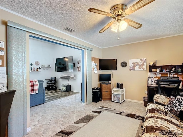 living room featuring ceiling fan, ornamental molding, a textured ceiling, and light tile patterned floors