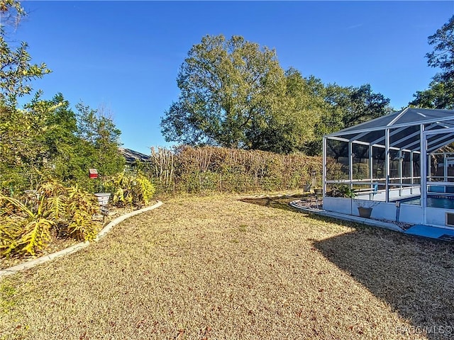 view of yard featuring glass enclosure