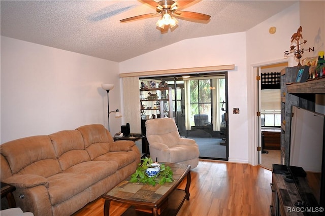 living room with lofted ceiling, a textured ceiling, ceiling fan, and light hardwood / wood-style flooring