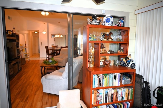 living room with wood-type flooring and a notable chandelier