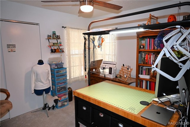 carpeted office featuring ceiling fan