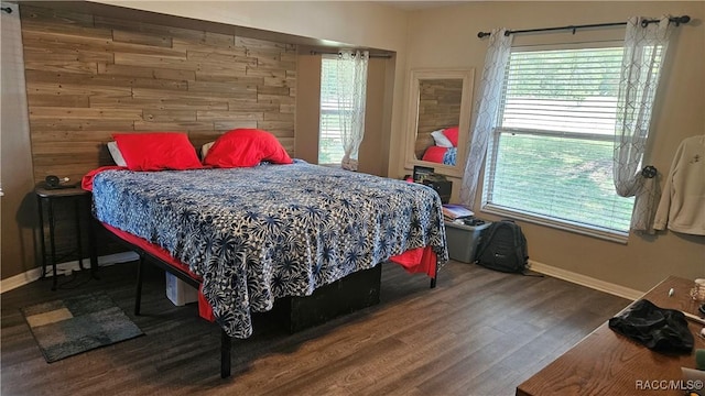 4889 N Peppermint Dr, Beverly Hills, FL 34465 - bedroom featuring baseboards, wooden walls, wood finished floors, and multiple windows