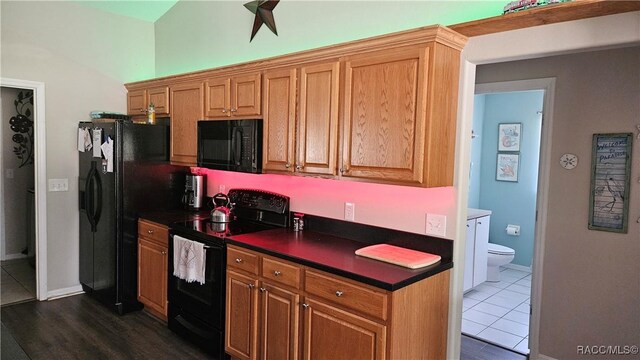 4889 N Peppermint Dr, Beverly Hills, FL 34465 - kitchen featuring black appliances, dark countertops, and baseboards