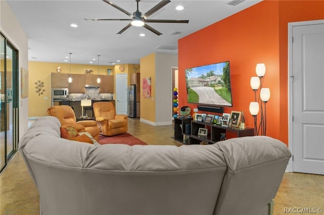 living room with ceiling fan and light tile patterned floors