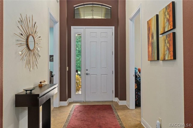 entrance foyer featuring plenty of natural light and light tile patterned flooring