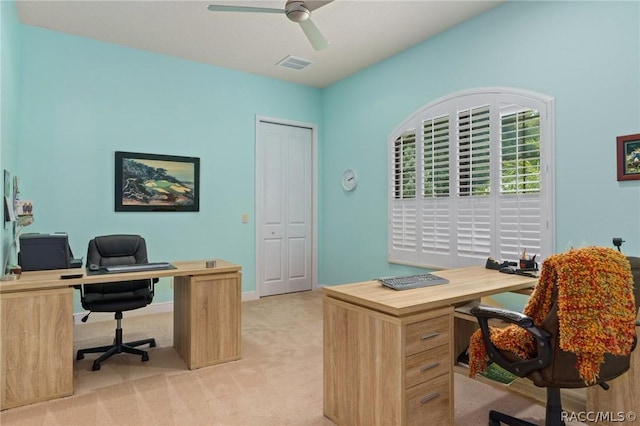 carpeted home office featuring ceiling fan