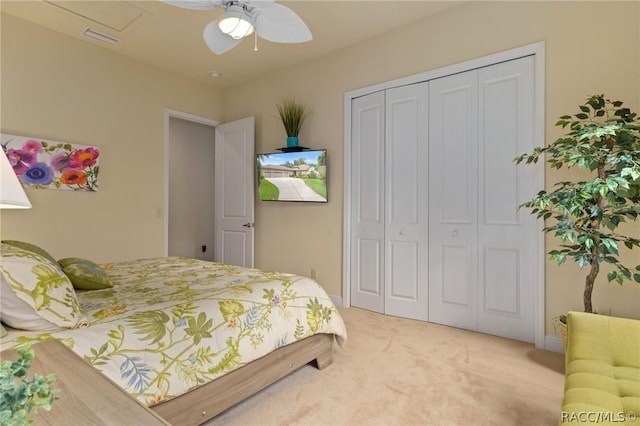 carpeted bedroom featuring a closet and ceiling fan