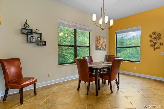 tiled dining area featuring a notable chandelier