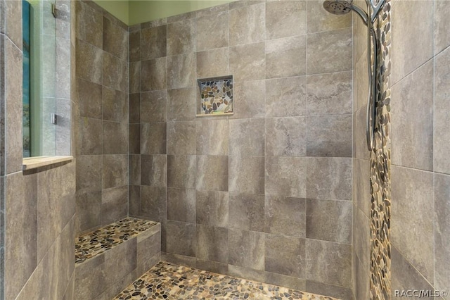 bathroom with a tile shower