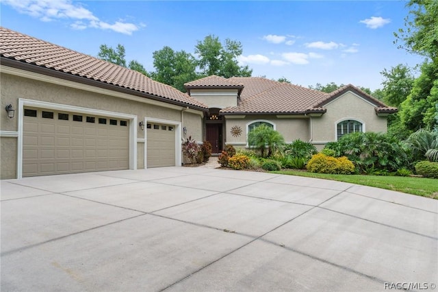 mediterranean / spanish-style home with a garage