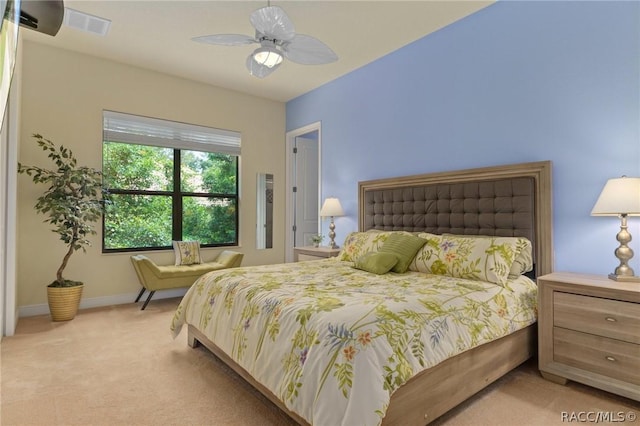 bedroom featuring light colored carpet and ceiling fan