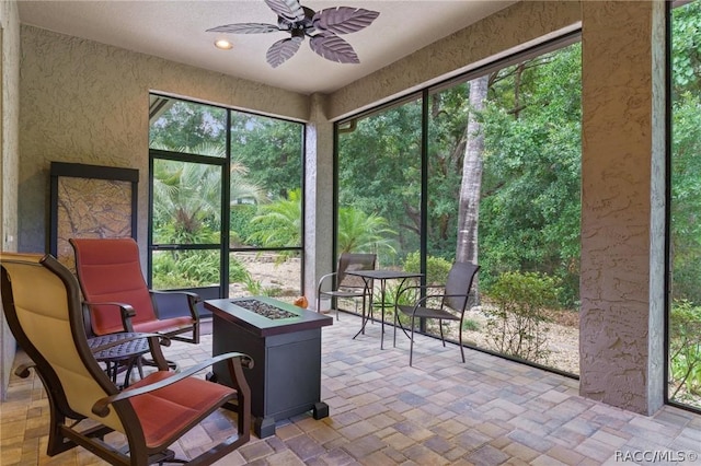 sunroom / solarium featuring ceiling fan