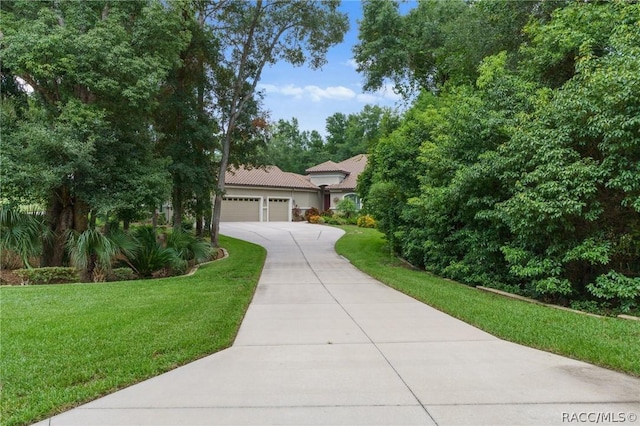 view of front of home featuring a garage and a front lawn