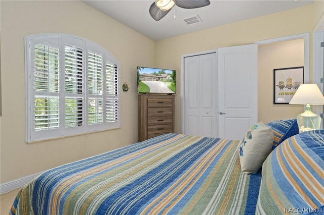 bedroom with a closet, ceiling fan, and carpet