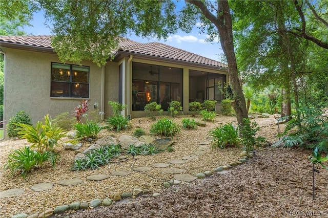 rear view of property featuring a sunroom