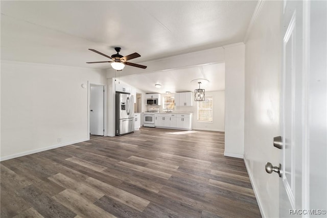 unfurnished living room with dark wood-style flooring, crown molding, baseboards, and lofted ceiling