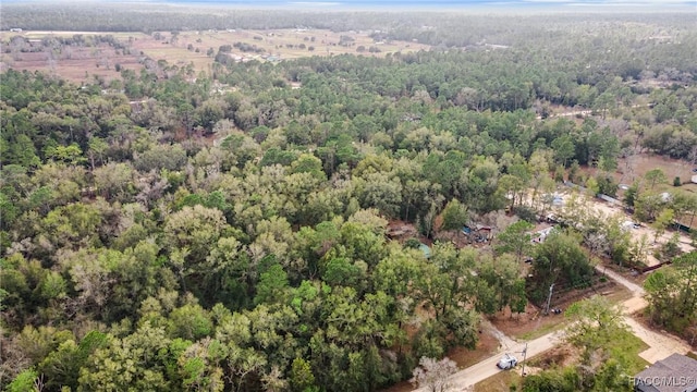 drone / aerial view featuring a wooded view