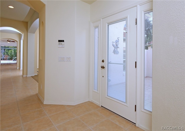 tiled foyer with ceiling fan