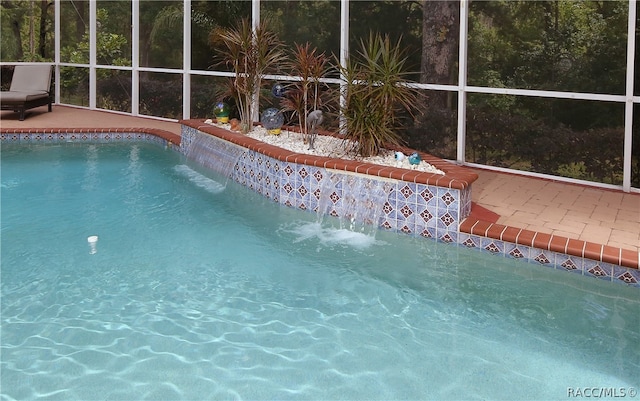 view of swimming pool with pool water feature