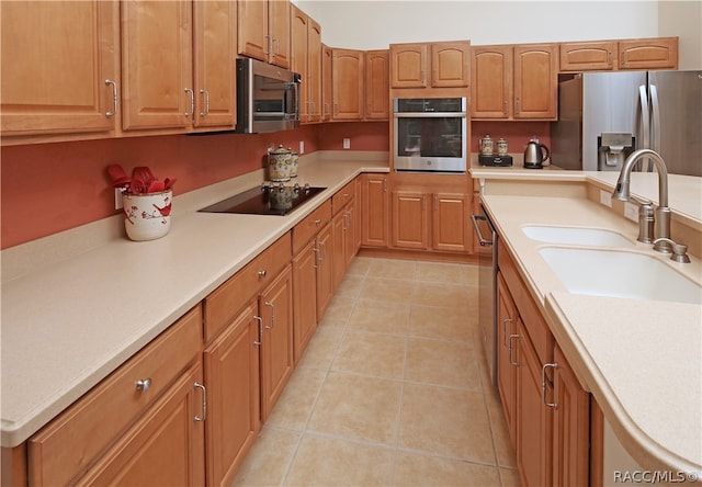 kitchen with light tile patterned floors, sink, and appliances with stainless steel finishes