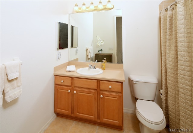 bathroom featuring tile patterned floors, vanity, and toilet