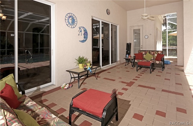 view of patio / terrace featuring glass enclosure and ceiling fan