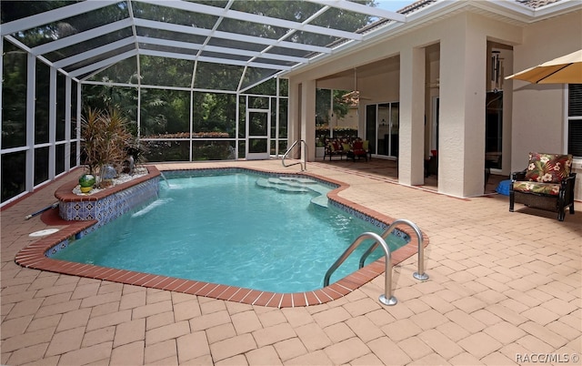 view of swimming pool featuring glass enclosure, pool water feature, and a patio