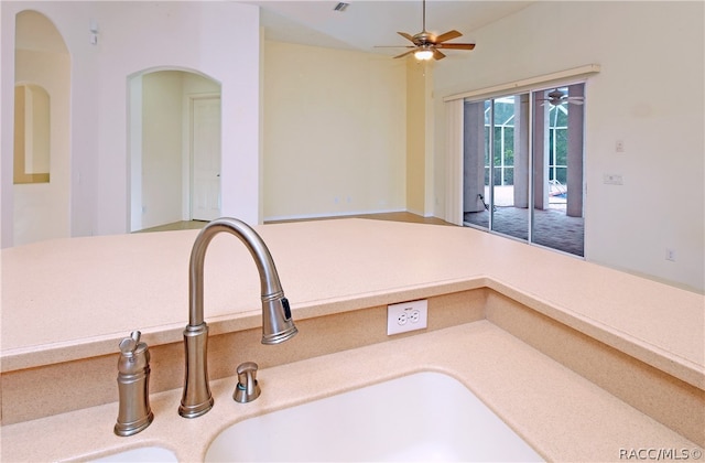 kitchen featuring ceiling fan and sink