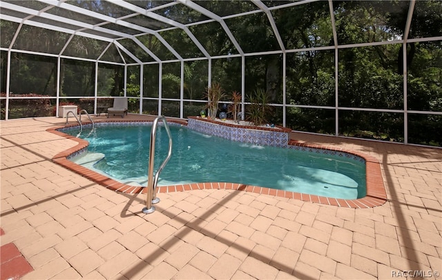 view of pool featuring pool water feature, glass enclosure, and a patio