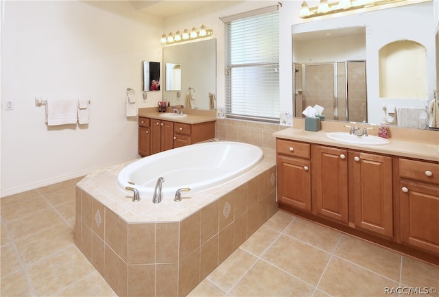 bathroom featuring tile patterned flooring, vanity, and plus walk in shower