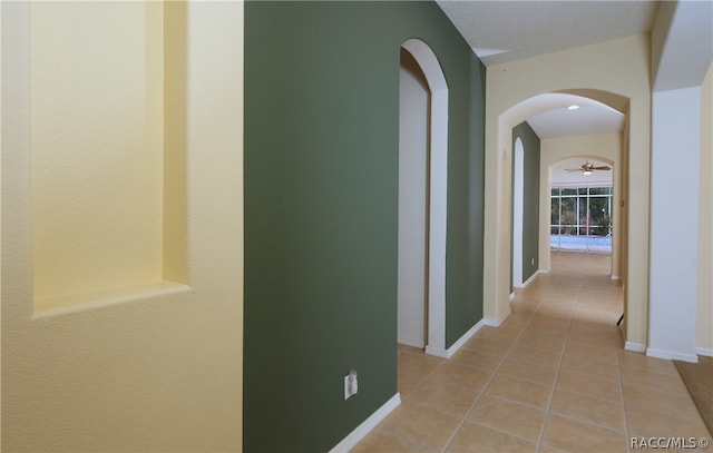 hallway with light tile patterned floors