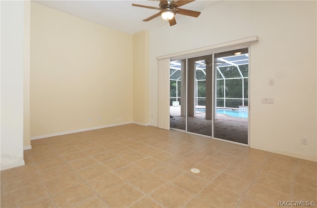 empty room with ceiling fan and light tile patterned floors