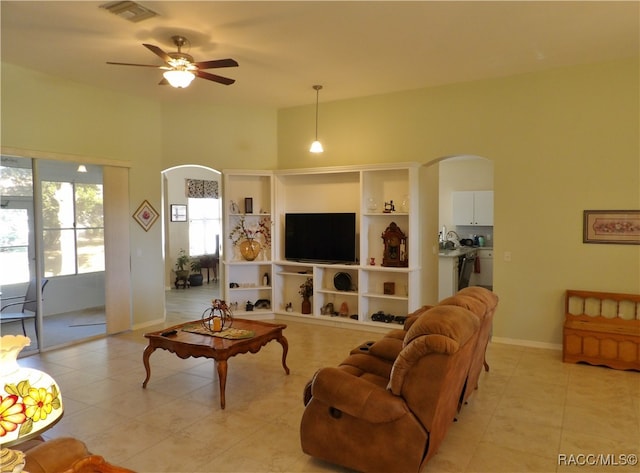 living room with light tile patterned floors and ceiling fan