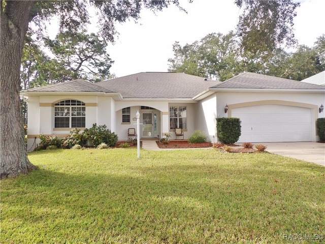 ranch-style home featuring a front yard and a garage