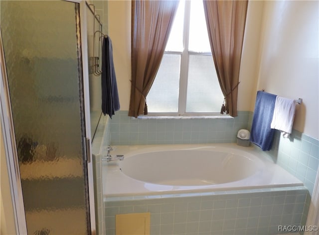 bathroom with shower with separate bathtub