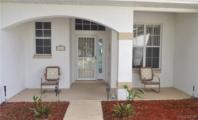 4614 N Crestline Dr, Beverly Hills, FL 34465 - doorway to property featuring stucco siding and a porch