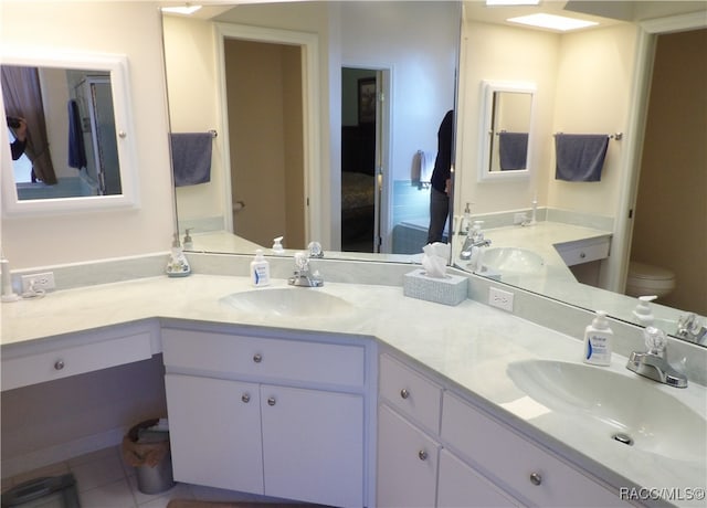 bathroom featuring tile patterned flooring, vanity, and toilet