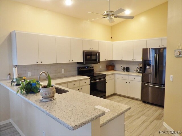 4614 N Crestline Dr, Beverly Hills, FL 34465 - kitchen featuring black electric range oven, stainless steel fridge, a peninsula, ceiling fan, and decorative backsplash