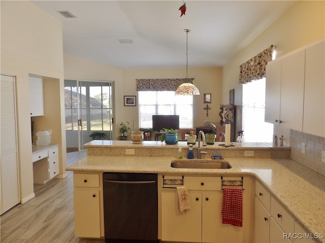 kitchen with sink, stainless steel dishwasher, kitchen peninsula, light hardwood / wood-style floors, and decorative light fixtures