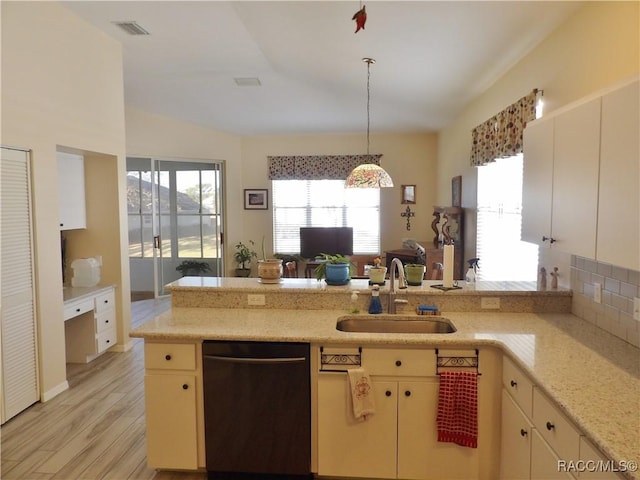 4614 N Crestline Dr, Beverly Hills, FL 34465 - kitchen with dishwashing machine, light wood-style flooring, hanging light fixtures, cream cabinets, and light stone countertops