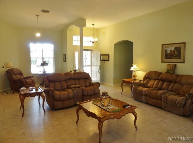 4614 N Crestline Dr, Beverly Hills, FL 34465 - living room featuring arched walkways, light tile patterned floors, and a chandelier