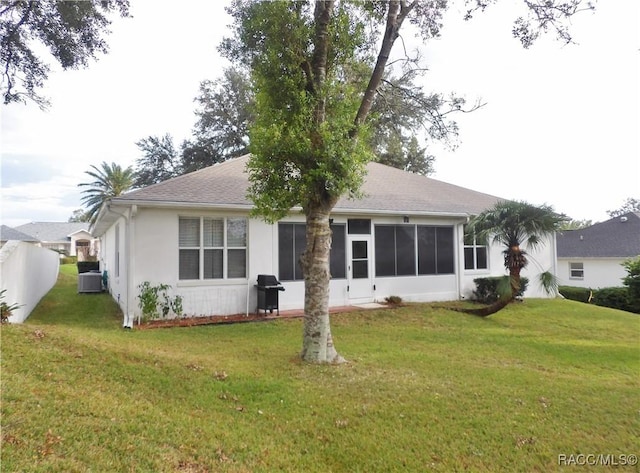 4614 N Crestline Dr, Beverly Hills, FL 34465 - rear view of house with a lawn, roof with shingles, stucco siding, and a sunroom