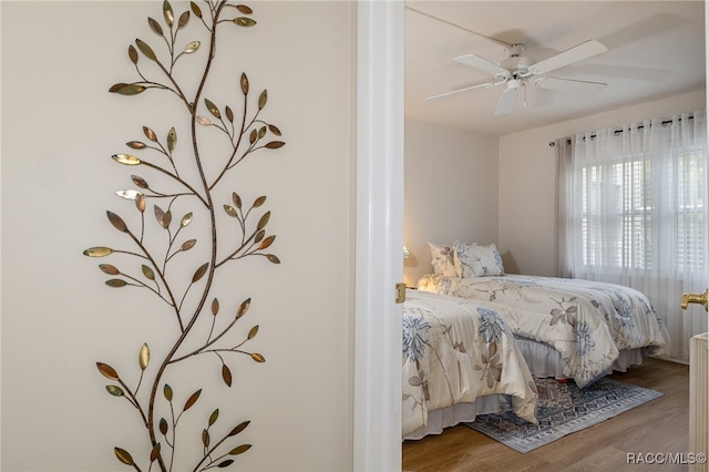 bedroom featuring ceiling fan and hardwood / wood-style flooring